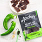 Country Archer Grass-Fed Beef Jerky Hatch Chile 2.5 oz package on counter with chiles and spices